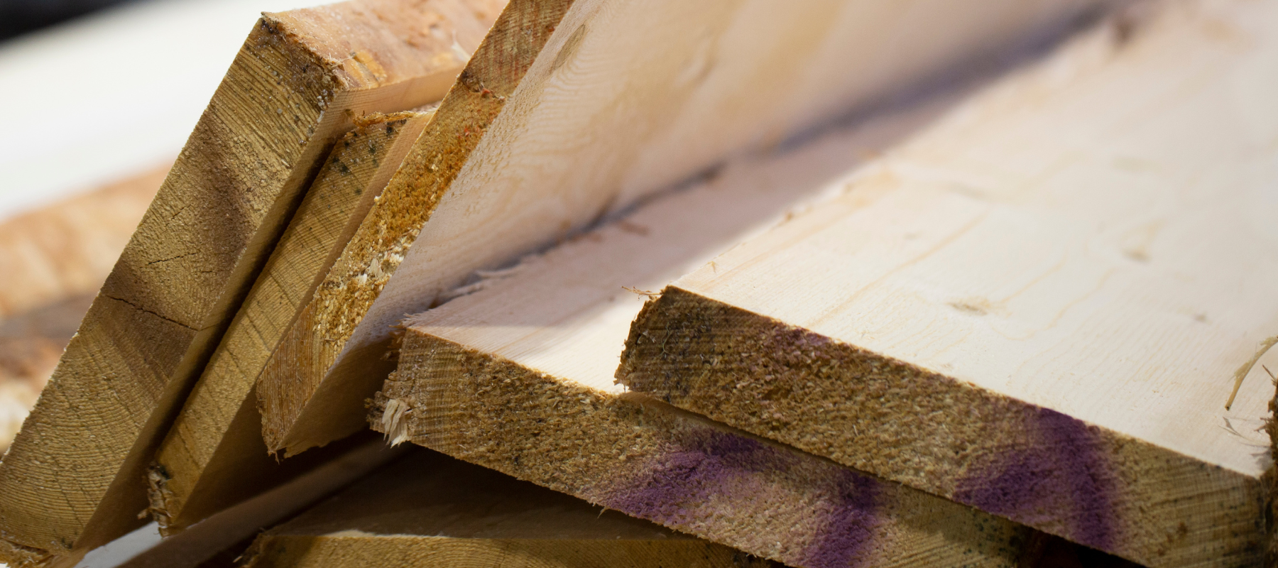 Stacked lumber boards.